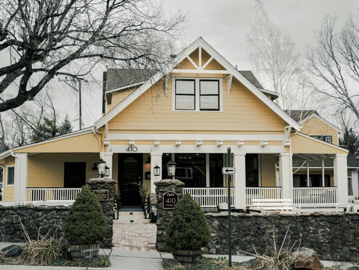 Yellow craftsman house with a white front porch