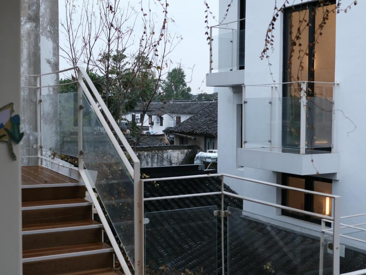 Exterior stairs and balconies with glass railings on a modern house